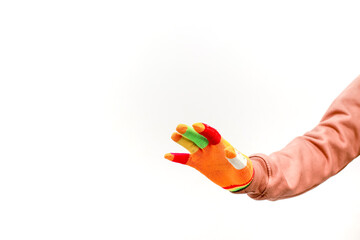 A hand wearing a colorful glove extending outwards against a white backdrop, showcasing playful creativity and vibrancy