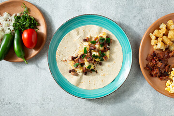 A top down view of a gluten-free breakfast burrito.