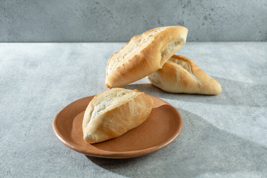 A view of a bolillo roll, on a plate.