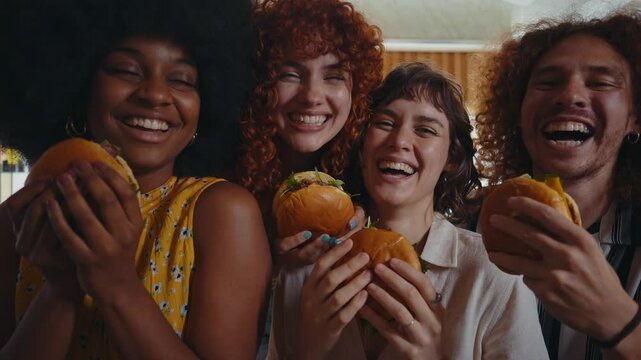 Friends gather in a nostalgic diner, relishing delicious burgers and refreshing sodas around a cozy booth, capturing a moment of joy and connection