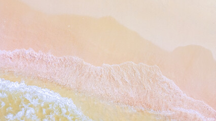 Ocean's Gentle Embrace: An aerial view captures the delicate dance of waves meeting the shore. Soft hues of the sky and water mingle seamlessly, creating a serene coastal scene.