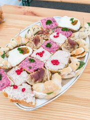Assorted gourmet finger sandwiches on platter