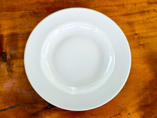 A Clean Plate: The perfect starting point for a culinary creation, this pristine white plate stands...