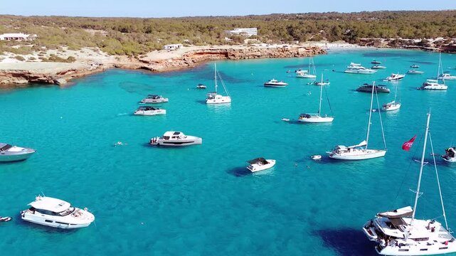 Aerial Drone View of group of Yachts or Flotilla in Formentera's Crystal Clear Cove