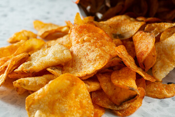 A closeup view of a pile of BBQ potato chips.