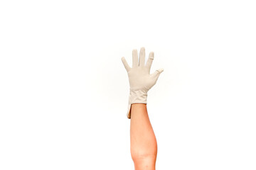 Hand wearing a surgical glove reaching up against a clean white background symbolizing protection