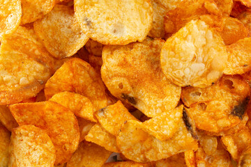 A top down view of a pile of BBQ potato chips, as a background.
