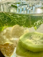 lemon and kiwi slices in water with mint, homemade lemonade