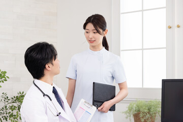 病室で打ち合わせをする医者と看護師