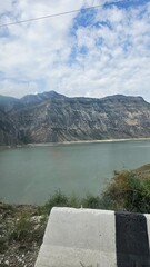 Crystal-clear mountain lake nestled among emerald green slopes and rugged peaks. Peaceful...