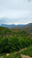 Crystal-clear mountain lake nestled among emerald green slopes and rugged peaks. Peaceful wilderness reflecting in still waters under summer skies &mdash; perfect nature escape.

