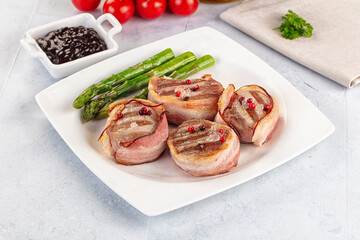 Tasty grilled pork medallion with bacon