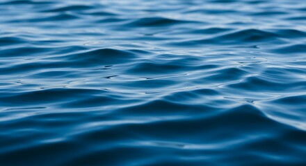 Naklejka premium Gently undulating dark blue water surface with subtle ripples and texture.