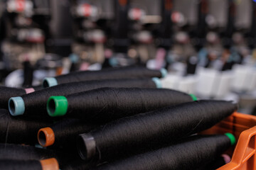 Black Spools of Thread on Yarn Production Line Closeup Textile Industry Manufacturing Equipment