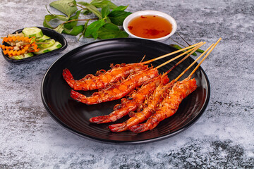 Grilled prawn skewer served sauce