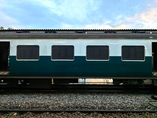 Fototapeta premium Side View of a Teal and White Train Carriage