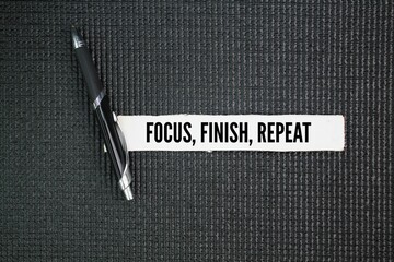 A pen with the three words Focus, finish, repeat. productivity concept emphasizing the importance...