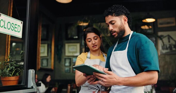Waiter, team and talk with tablet at cafe, closed sign or stress for crisis, bankruptcy or app at front door. Man, woman and partner with lost profit, debt or worry for revenue results at coffee shop