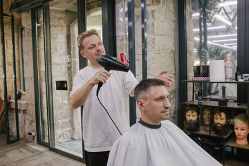 Barbershop. Men's hairdresser at work. Barber at work. Men's haircut in the salon.