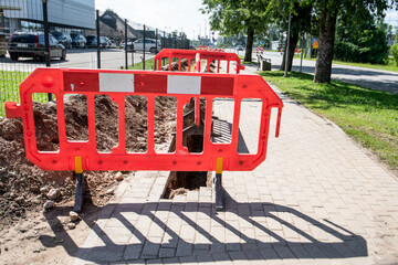 Urban Sidewalk Construction with Safety Barriers and Open Trench for Infrastructure Work