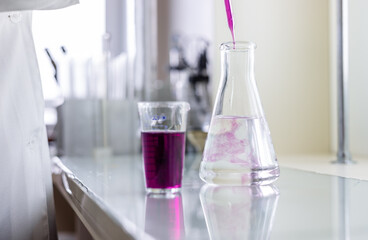 Chemistry laboratory glassware with color liquids. Laboratory analysis. Glassware with different...