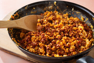 A view of a skillet of chorizo con huevos.