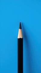 Vertical black pencil with sharp tip on textured blue background. Wood grain contrasts smooth casing. Lighting and focus highlight precision, simplicity, and clean design.

