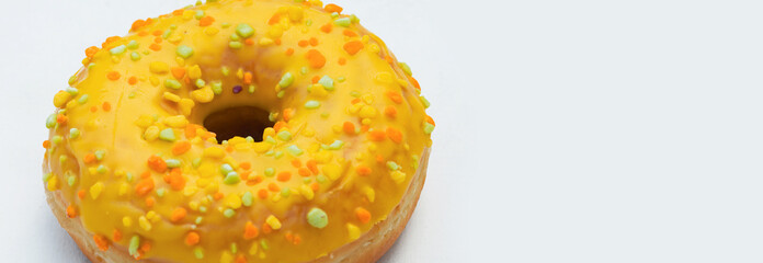 Colorful Sprinkle-Covered Donut on a White Background Showcasing Vibrant Textures and Sweet Appeal
