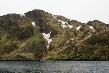 Rocky Fjordside Mountain with Snow