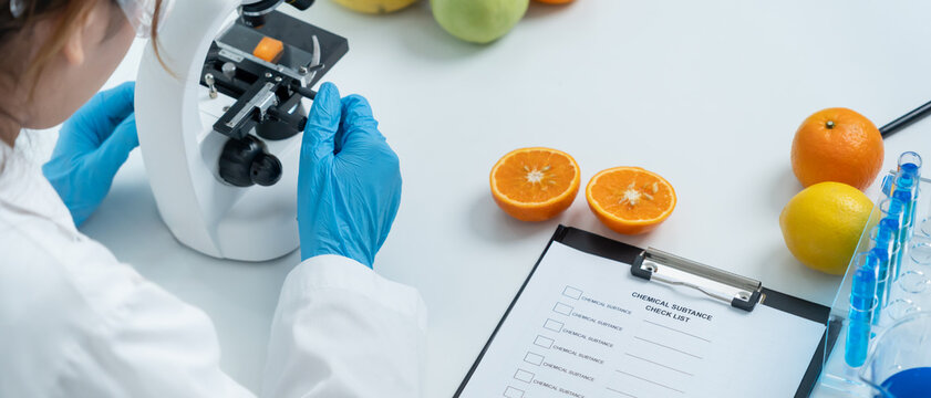 Scientist check chemical food residues in laboratory. Control experts inspect quality of fruits, vegetables. lab, hazards, ROHs, find prohibited substances, contaminate, Microscope, Microbiologist
