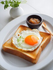 Sunny side up egg on toast breakfast recipe with jam and flowers on white plate food