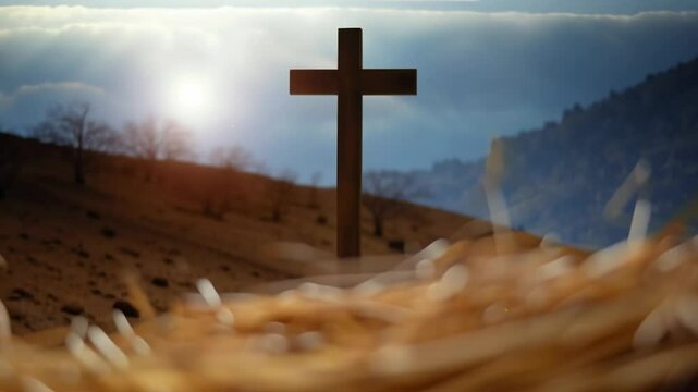 Baby jesus lies in a manger on hay, with the cross in the background. Christian nativity scene for Christmas.
