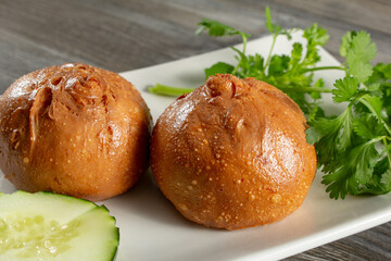 A closeup view of a plate of fried pork buns.