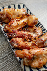 A view of a plate of garlic chicken wings.