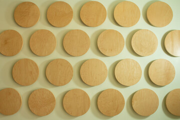 A view of a pattern of wooden discs on a wall, as a background.