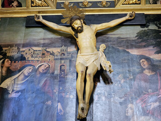 Crucifix of Jesus Christ with painted background in catholic church