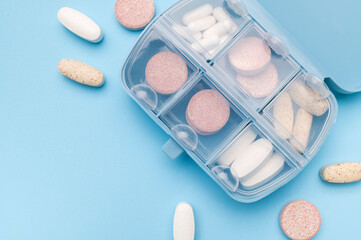 Blue pill organizer, pillbox with different vitamins, capsules, tablets, pills, dietary supplements...