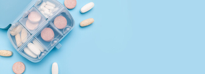 Blue pill organizer, pillbox with different vitamins, capsules, tablets, pills, dietary supplements...