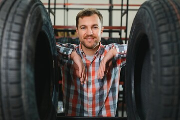 Man chooses winter car tires in the auto shop