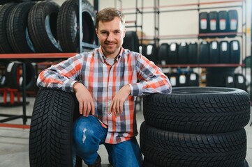 Man chooses winter car tires in the auto shop