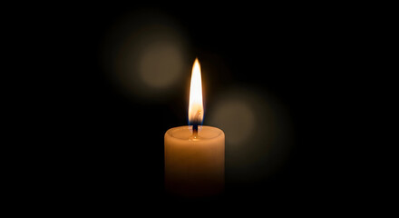 Burning candle in the dark background