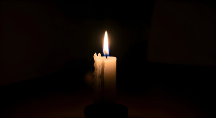 Burning candle in the dark background