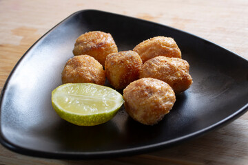 A view of a black triangle plate of polenta roasted potatoes.
