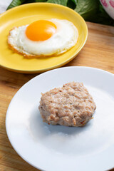 A view of a chicken sausage patty and a fried egg.