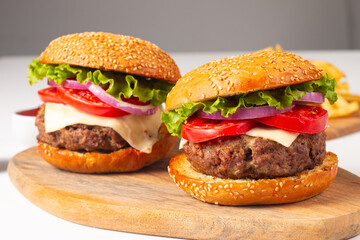 Hamburger made of beef, onion, tomato, lettuce, cheese and spices. Fresh burger closeup....