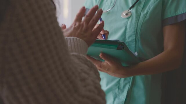 female doctor listening to complaints writing medical case report diagnosis, prescription for senior woman patient in office clinic, health records for treatment. healthcare nurse talking to elderly