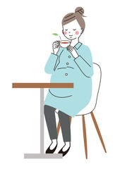 ハーブティーを飲んでリラックスしている妊婦さん