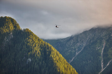 Helicopter rescue training simulation in a mountain range wood. Accident