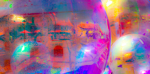 A vibrant, abstract artwork featuring a close-up of a shiny, surface reflecting multicolored light....