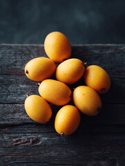 Vibrant pile of exotic yellow fruits on rustic wood. Captures freshness and natural beauty. Perfect for culinary, healthy eating, or tropical themes.
